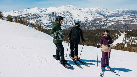 Family taking a break on a ski run at June Mountain.