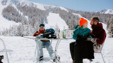 friends dining outside in the snow