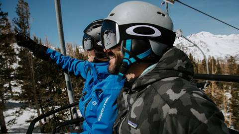 A instructor and student sharing a chairlift ride during a private lesson at June Mountain