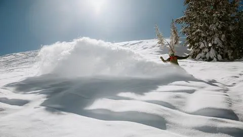 snowboarder riding in powder