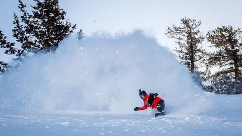 snowboarder slashing powder