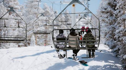 friends on a lift going uphill