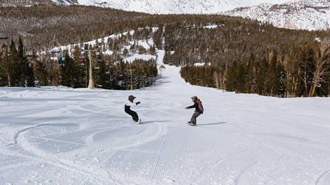 kids snowboarding together using kids snowboard rentals at june mountain